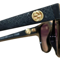 Gucci Schwarze Sonnenbrille im Retrolook mit geprägten Bügeln